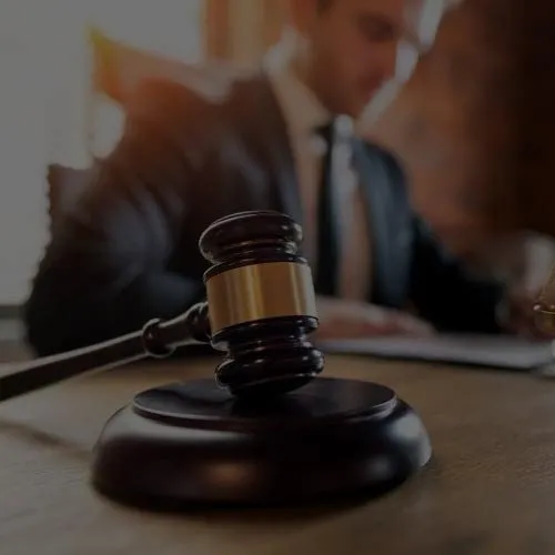 A judge's gavel resting on a sound block