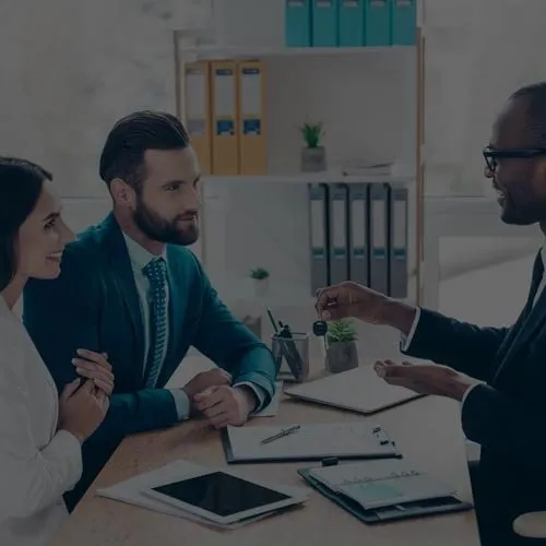 Three professionals in a meeting at a conference table
